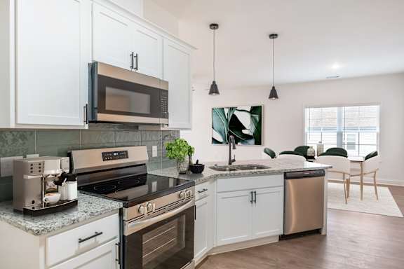 A modern kitchen with a stainless steel dishwasher and oven.