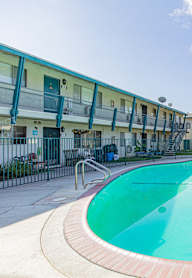 a swimming pool with a building in the background