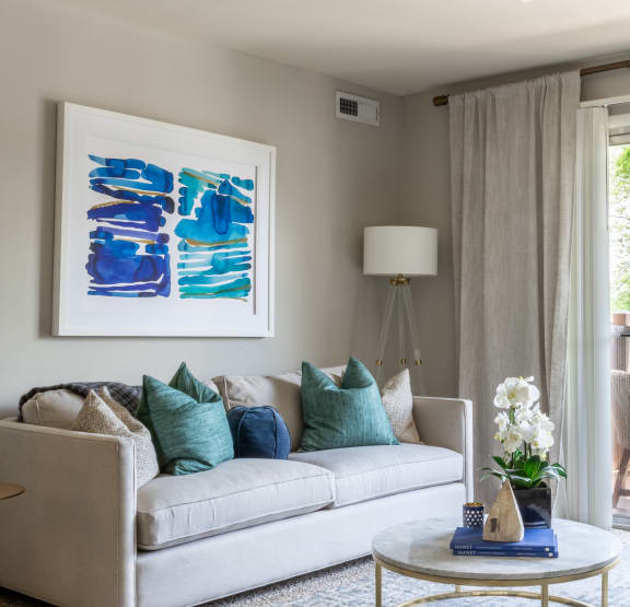  a living room with beige walls and a couch and a chair Indianapolis, IN