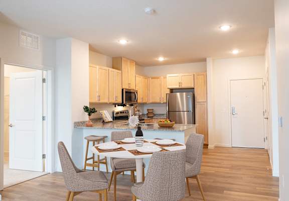 an open kitchen and dining room with a table and chairs