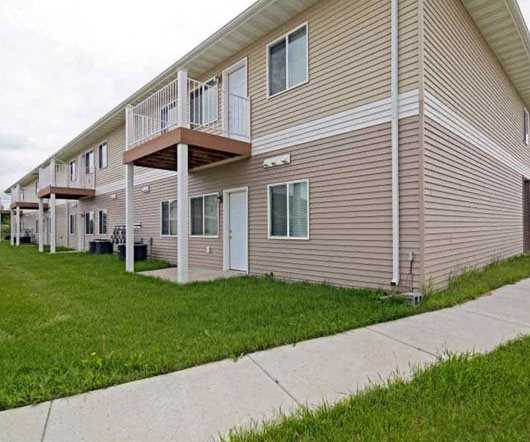 Outside Dakota Apartments The exterior and green space at Dakota Apartments.