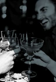 Two people toasting with drinks at a party.at Hollywood Ardmore, Los Angeles, CA 90028