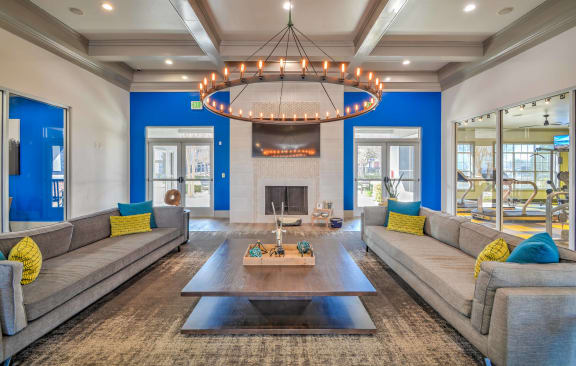 a living room with couches and a coffee table and a fireplace at The Atlantic Station, Texas, 76131