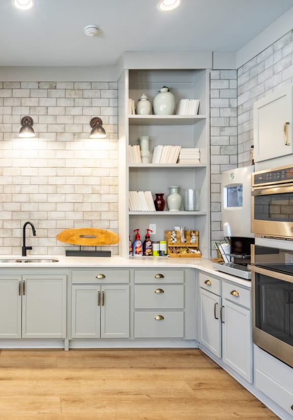 a kitchen with white cabinets and stainless steel appliances