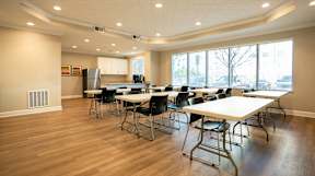 A conference room with a long table and chairs.