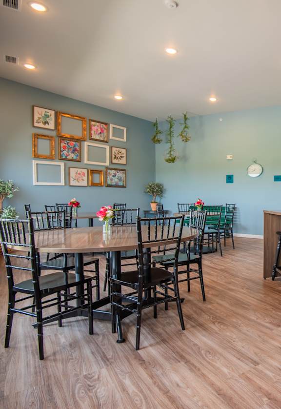 A kitchen with a dining table and chairs.