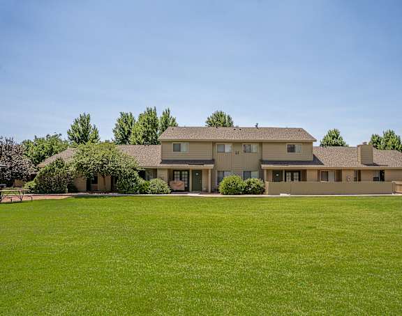 A large house with a lawn in front.