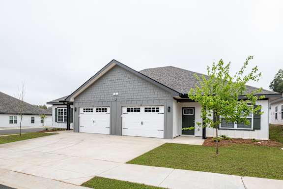 A grey house with a white garage door.