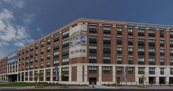 a large brick building with a sign on the side of it at The Enclave, Jersey City, New Jersey