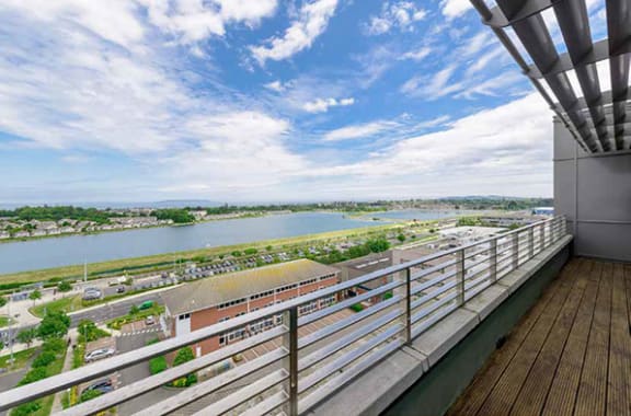 a balcony with a view of a city and a river