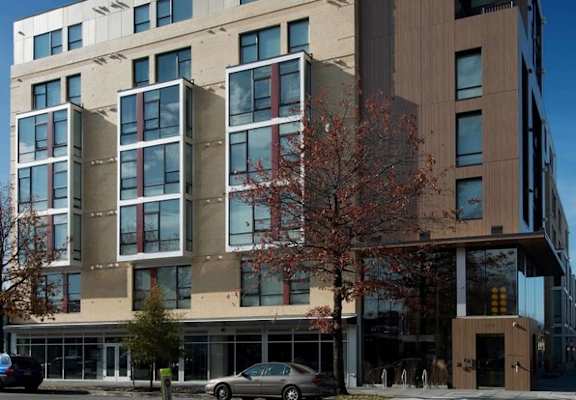 A modern building with a mix of beige and brown panels.
