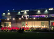 Thumbnail 2 of 14 - a large building with a large lawn in front of it and a large group of people standing
