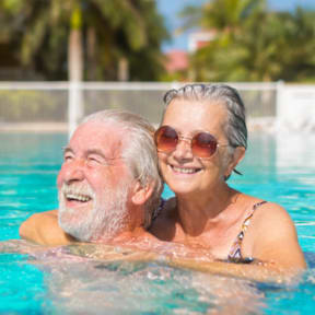 Man and Woman Smiling while in Pool