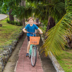 Boy Smiling while Riding Bike