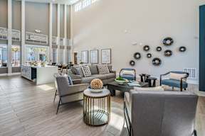 A living room with a grey couch and a coffee table.