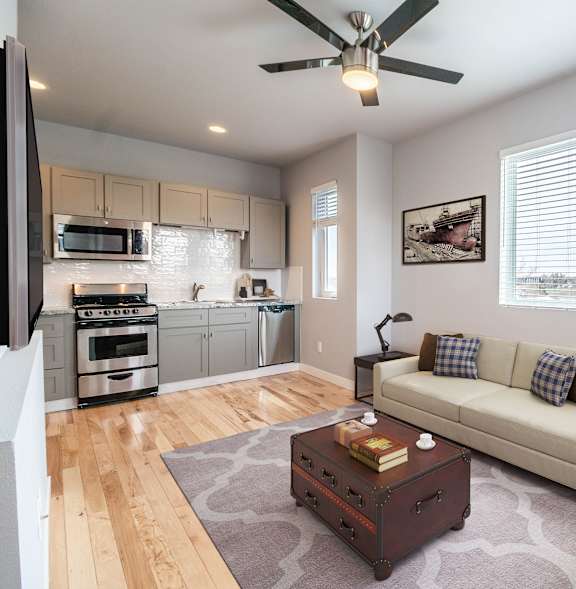 A living room with a white couch and a coffee table.