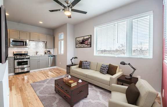 A living room with a white couch and a coffee table.