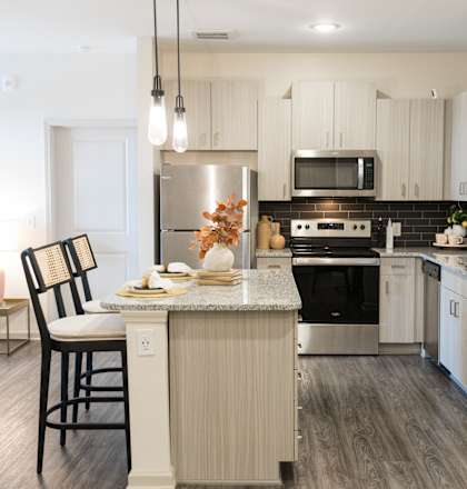 A modern kitchen with a dining table and chairs.