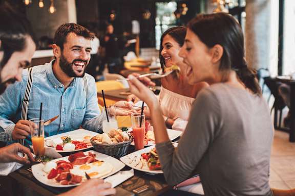 A group of people enjoying a meal together at a restaurant.