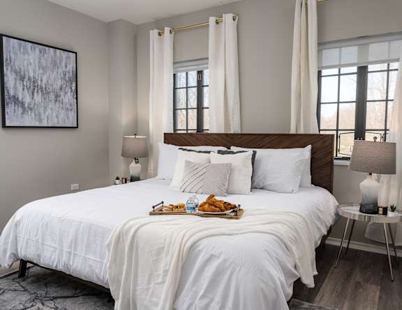 a bedroom with a bed and a tray of food on it