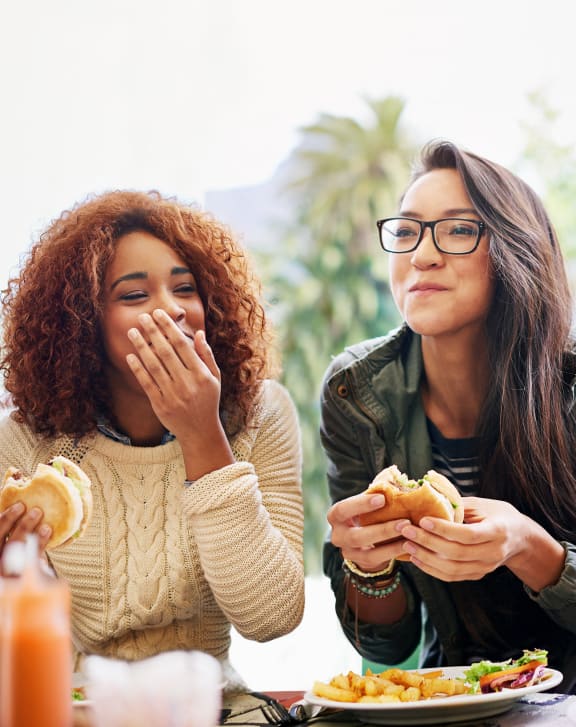 a group of people sitting at a table eating food