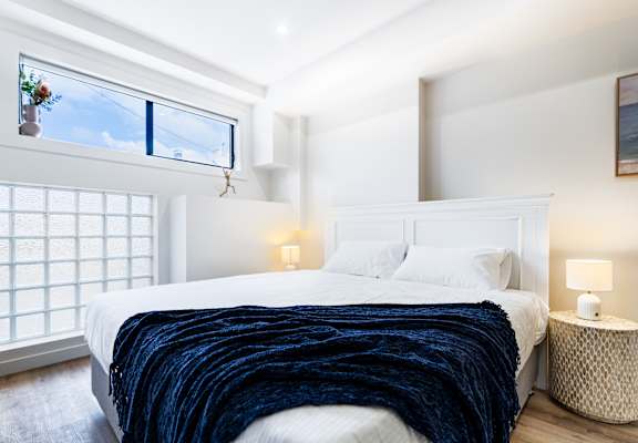 a bedroom with a large bed and a window