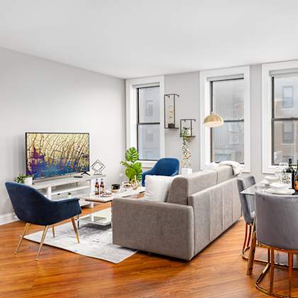 a living room with a couch and a table with chairs