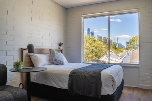 a hotel room with a bed and a large window