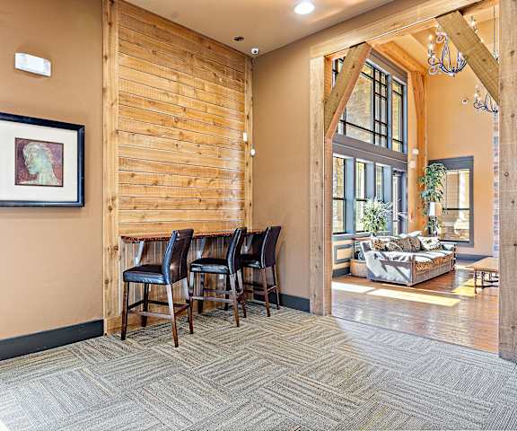 a dining area with a wooden table and four leather chairs at Las Brisas Apartment Homes, Round Rock, TX