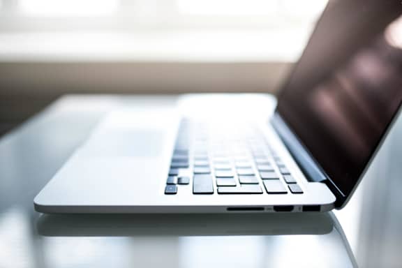A laptop is open and placed on a table.