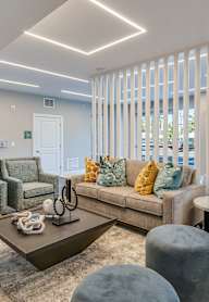 A living room with a couch, chairs, and a coffee table.