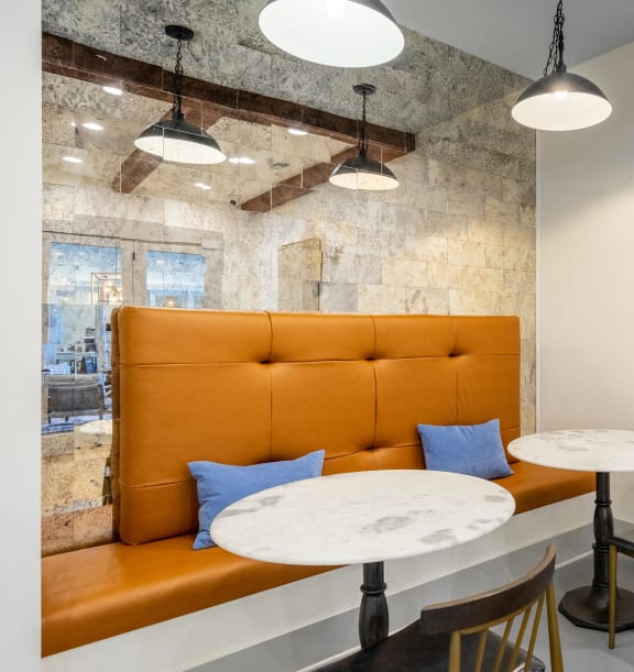 a seating area with two tables and a leather couch