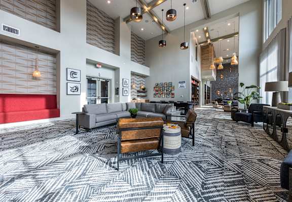 a large lobby with couches and chairs and a table at The Monroe Apartments, Austin, 78741