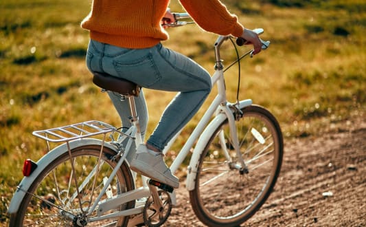a person riding a bike down a dirt road