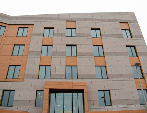A building with a grey facade and orange accents.