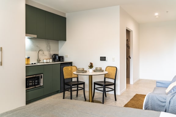 a kitchen and dining area with a table and chairs