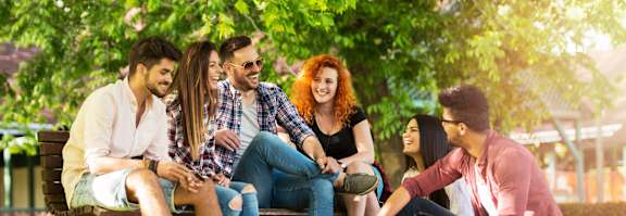 a group of people sitting on a park bench