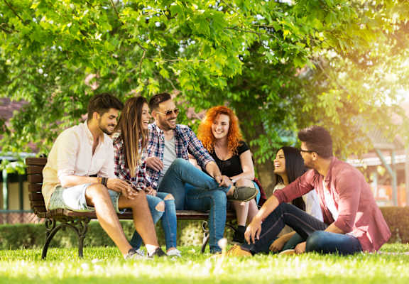 a group of people sitting on a park bench