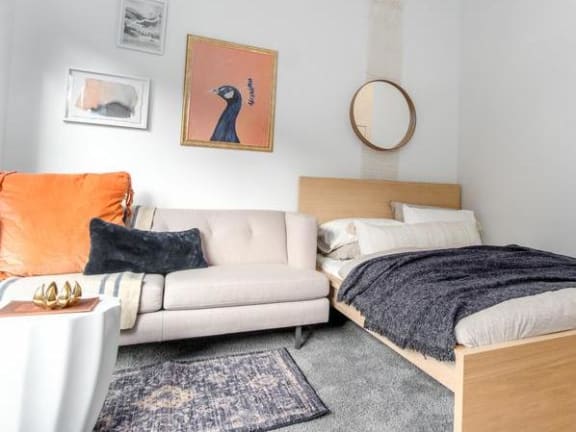 a living room with a couch and a bed