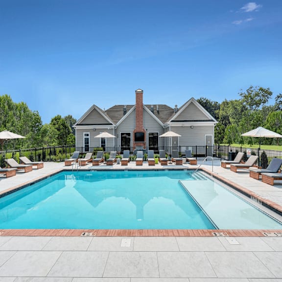 A large house with a pool in front.