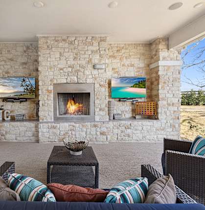 the living room has a fireplace and a tv on the wall at North Creek, Texas, 78634