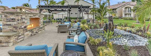 a patio with furniture and a fireplace