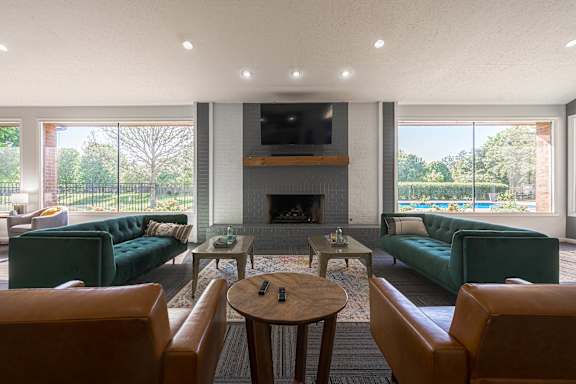 A living room with a fireplace and a television.
