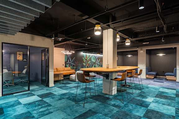 A room with a long table and chairs. at Textile Apartments, Cincinnati, OH, 21286