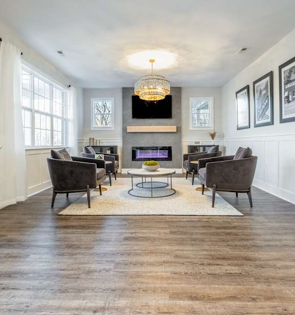 a living room with couches and chairs and a fireplace