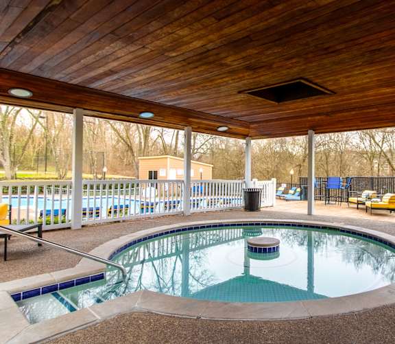 A wooden deck overlooks a small pool.