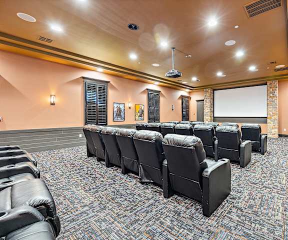 a large room with a projector screen and leather chairs at Las Brisas Apartment Homes, Round Rock, TX