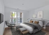 Thumbnail 6 of 25 - A modern bedroom with a large bed and a chair.