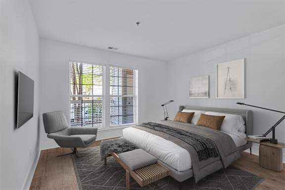 A modern bedroom with a large bed and a chair.