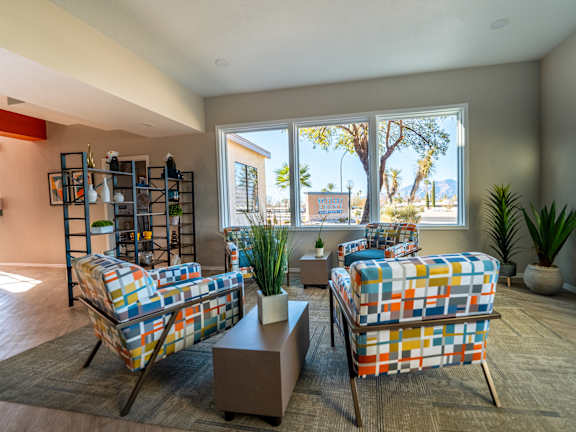 A living room with two chairs and a table.